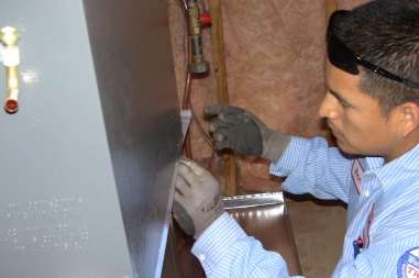Homeowner discussing HVAC financing options with technician